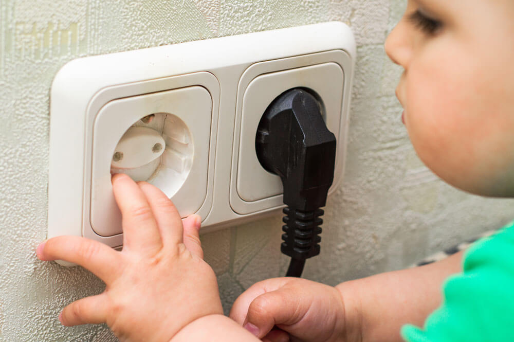 Child Touching an Outlet