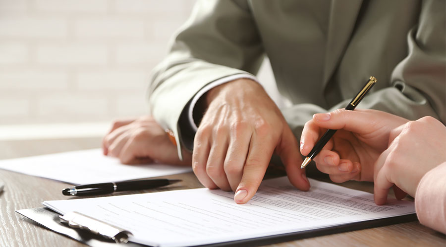 hands writing lawful paperwork